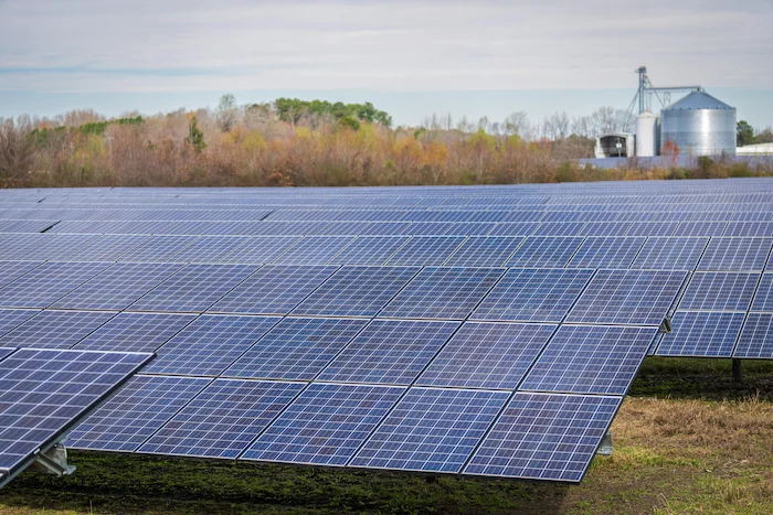 pexels-nc-farm-bureau-mark-15751130 Solar Technician Carrying Solar Panel